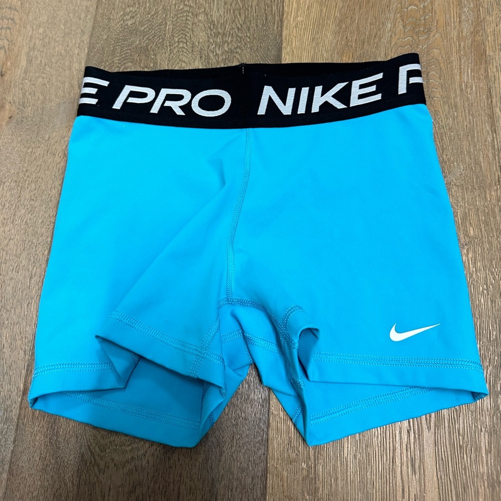 These are blue Nike pros in a size S